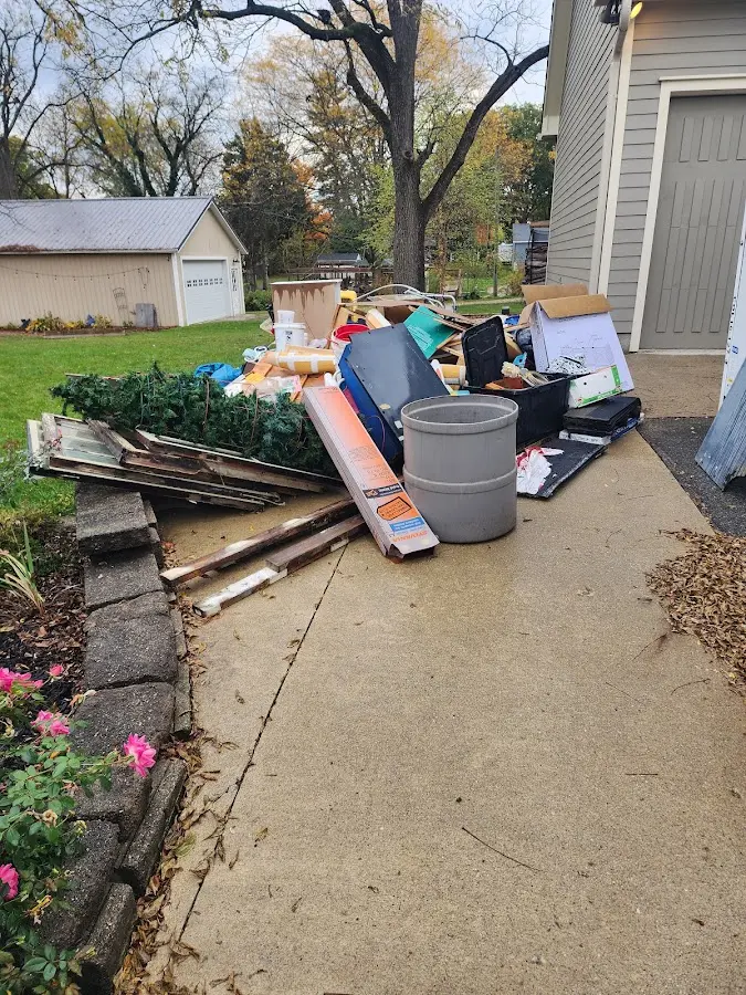 Dumpster being loaded with debris for 12 Yard Dumpster Rental in Park City
